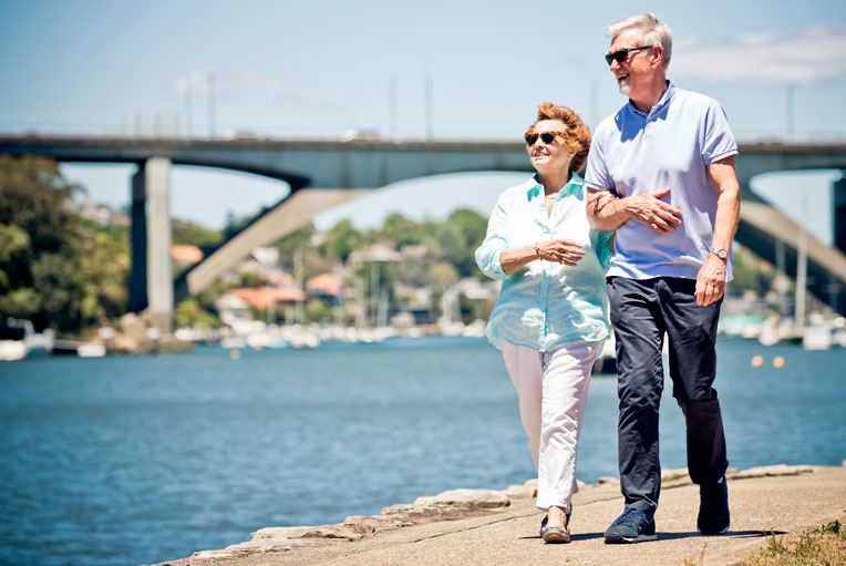 Elderly couple walking by the river